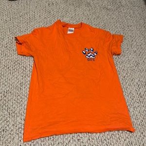 Orange t-shirt with paw print on it